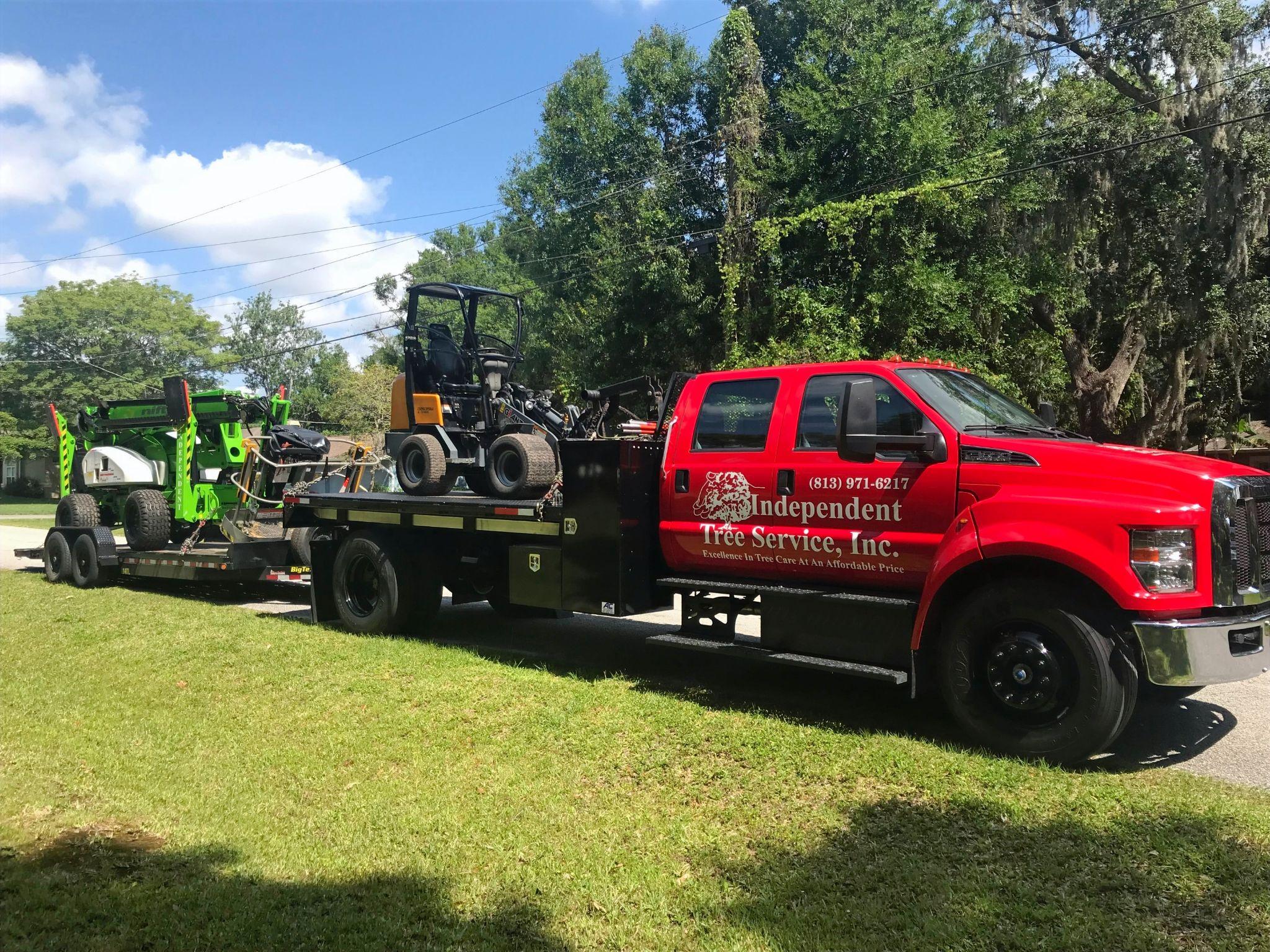 Independent Tree Services truck hauling tree care equipment.